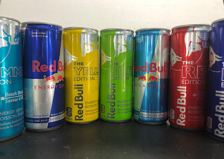 Shelf of Red Bull energy drinks in multiple editions