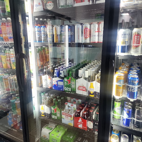 Glass-door coolers stocked with cold beer, cider and tall cans